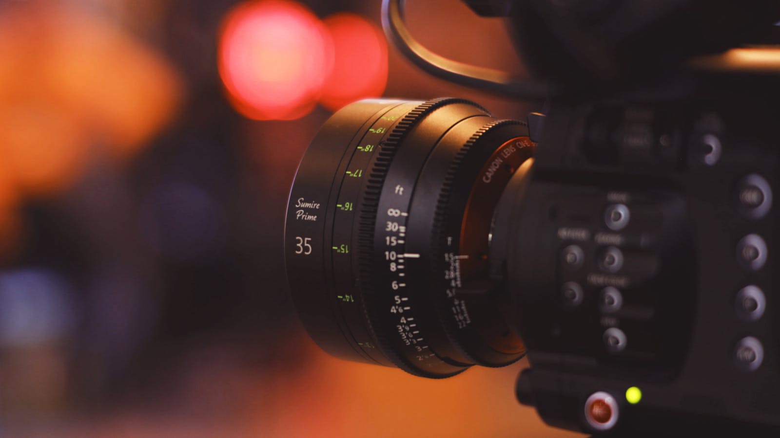 Close-up of an optical camera lens reflecting light