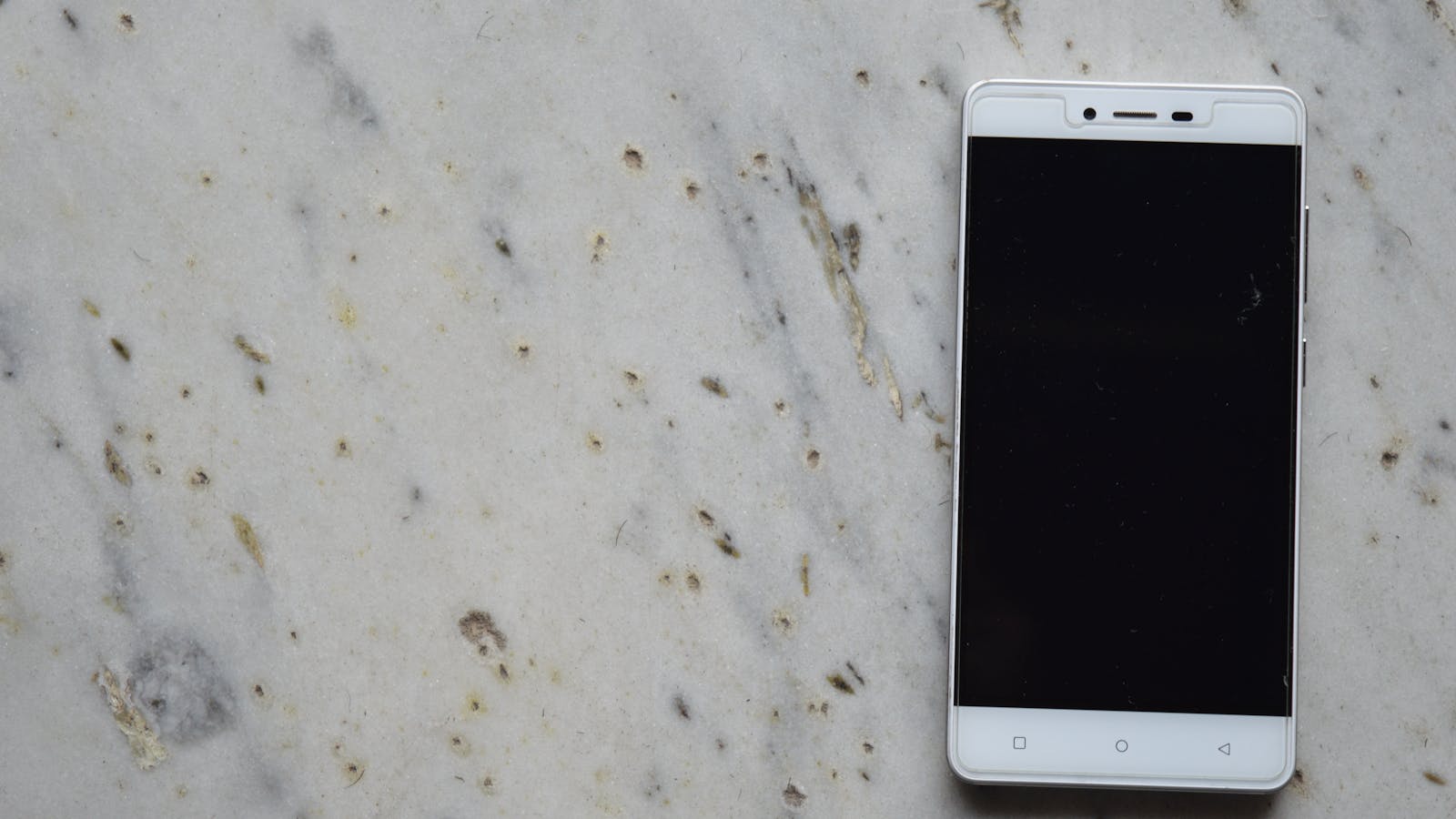 Android phone displaying app development tools on a desk